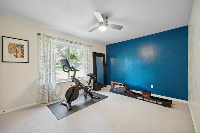 exercise area with ceiling fan and carpet floors