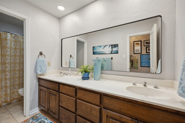 bathroom featuring tile patterned flooring, vanity, and toilet