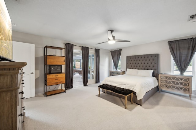 bedroom featuring access to exterior, ceiling fan, and light carpet