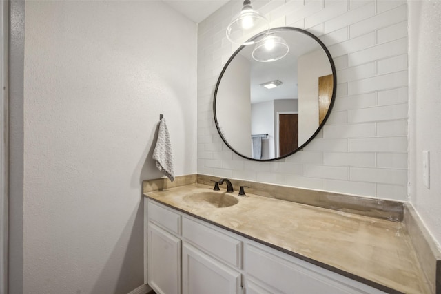 bathroom with vanity and tasteful backsplash