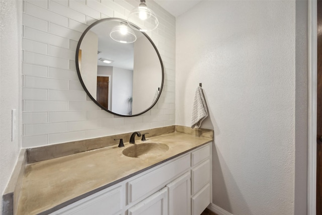 bathroom featuring vanity and tasteful backsplash