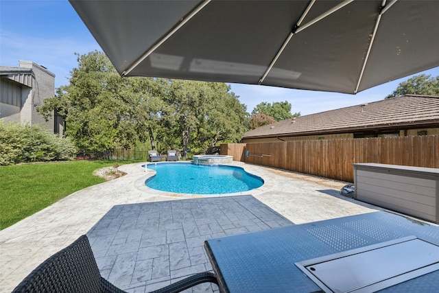 view of swimming pool featuring a lawn, a patio area, and an in ground hot tub