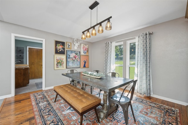 dining area featuring hardwood / wood-style flooring and a notable chandelier