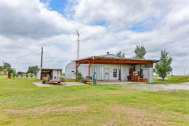 back of house with french doors, an outdoor structure, a yard, and a patio area