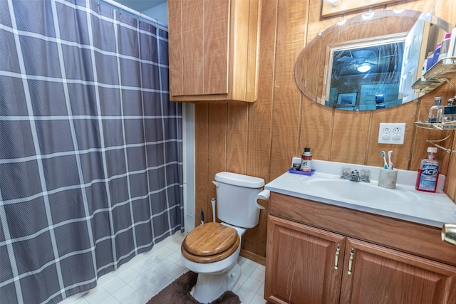 bathroom with walk in shower, vanity, toilet, and tile patterned floors