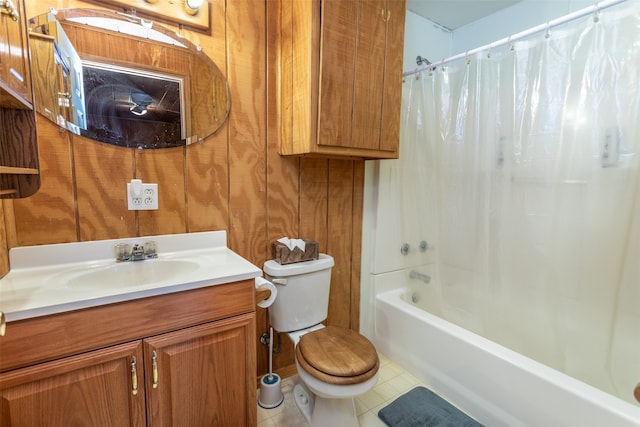 full bathroom with vanity, wood walls, tile patterned flooring, shower / tub combo, and toilet