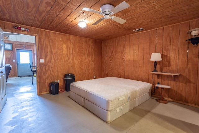 bedroom with wood ceiling, wooden walls, and ceiling fan