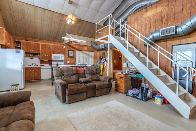 living room with wood walls and sink