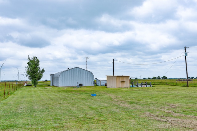 view of yard featuring a storage shed and a rural view