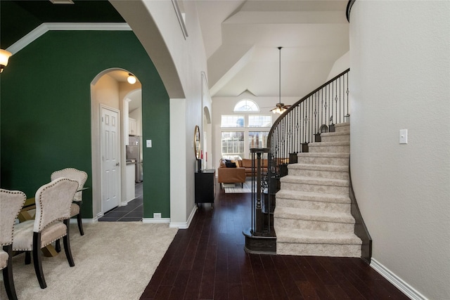 entrance foyer with ceiling fan, dark hardwood / wood-style flooring, and crown molding