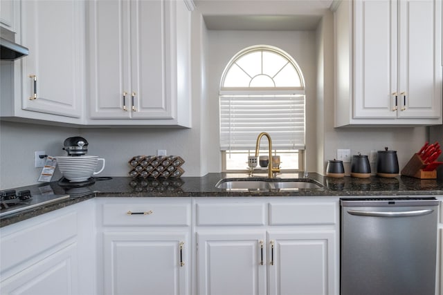 kitchen featuring white cabinetry, dishwasher, dark stone counters, and sink