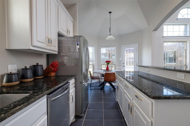 9736 Makiposa Ln, Fort Worth, TX 76177 - kitchen with stainless steel dishwasher, white cabinets, dark tile patterned flooring, plenty of natural light, and vaulted ceiling