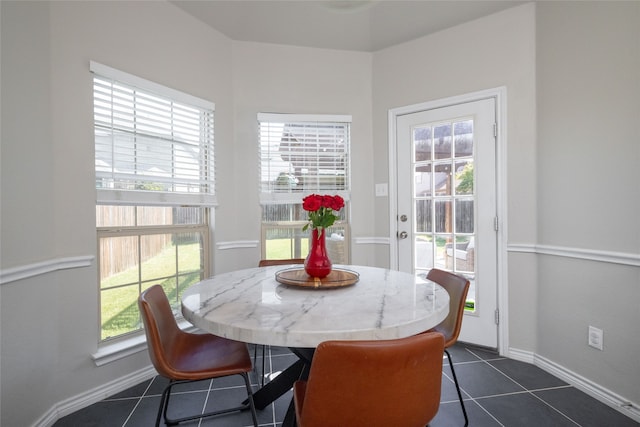 dining room featuring dark tile patterned flooring