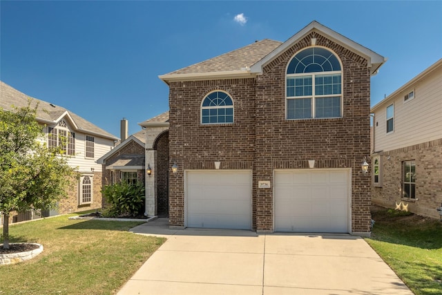 front facade with a front yard and a garage