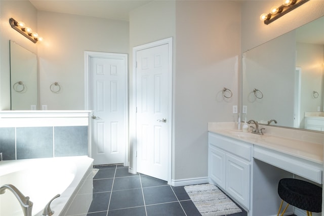 bathroom with tile patterned floors, tiled tub, and vanity