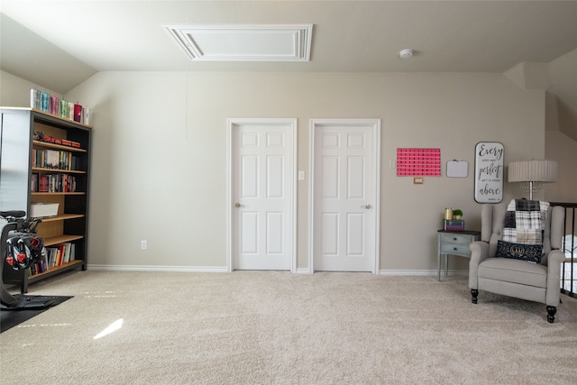 sitting room featuring light colored carpet and vaulted ceiling