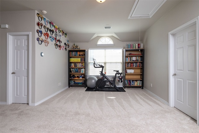 exercise room with light colored carpet and lofted ceiling