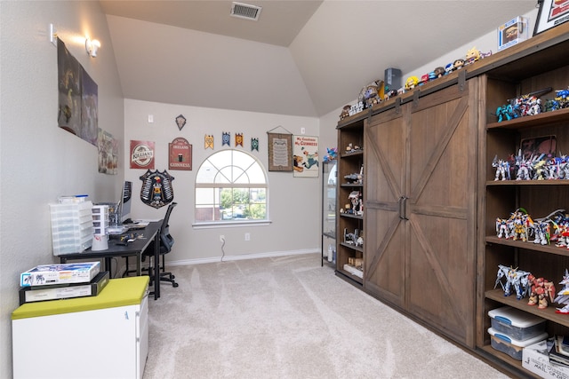 home office featuring light carpet and lofted ceiling