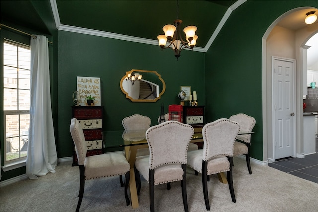 carpeted dining room featuring vaulted ceiling, crown molding, and a chandelier