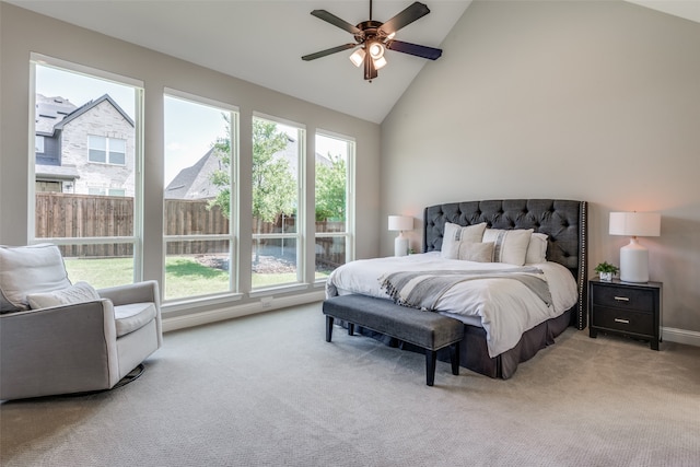 bedroom featuring ceiling fan, high vaulted ceiling, and multiple windows