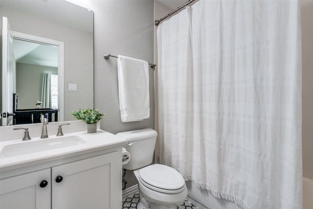 full bathroom with toilet, tile patterned floors, vanity, and shower / tub combo with curtain