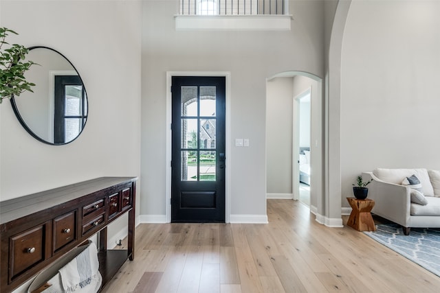 foyer with a high ceiling and light wood-type flooring