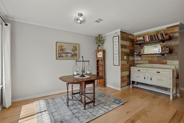 office area with wood walls, light hardwood / wood-style floors, and crown molding