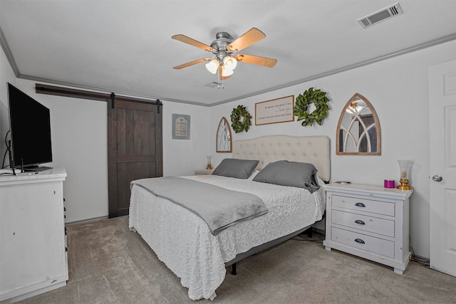 carpeted bedroom featuring ceiling fan, a barn door, and crown molding