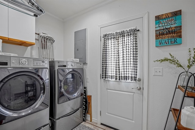 laundry area featuring independent washer and dryer, electric panel, and ornamental molding