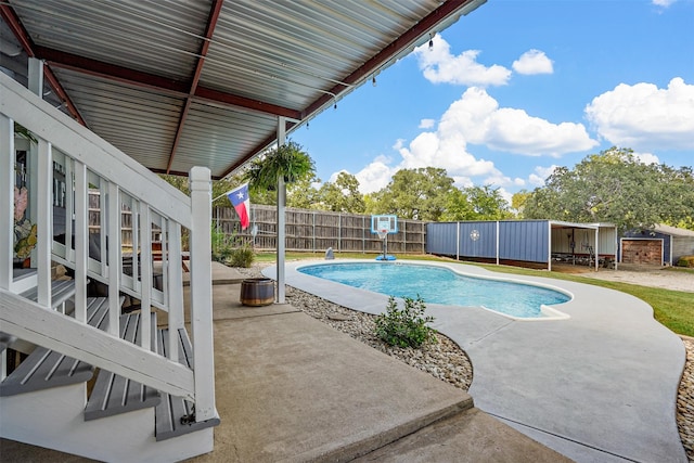 view of pool with a patio area and an outdoor structure