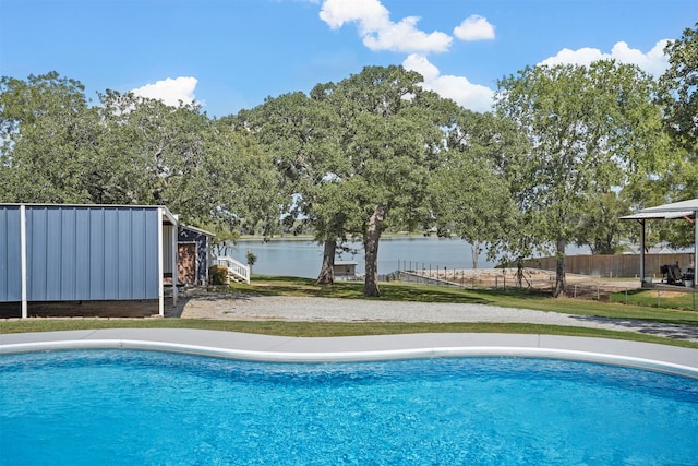 view of swimming pool featuring a water view