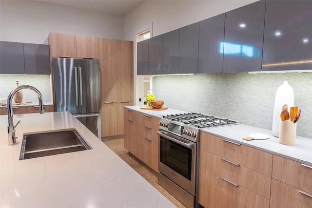 kitchen with appliances with stainless steel finishes, decorative backsplash, light brown cabinetry, and sink