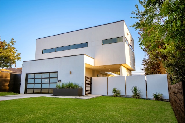 contemporary home featuring a front lawn and a garage