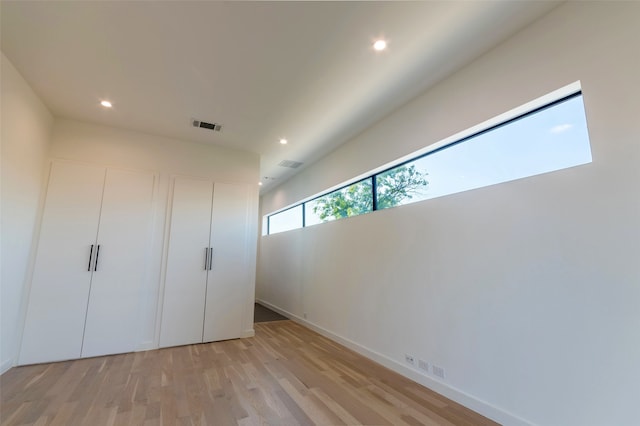 unfurnished bedroom featuring light wood-type flooring