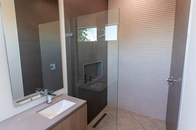 bathroom with vanity, a shower, and parquet floors