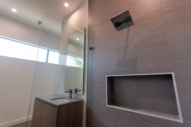 bathroom featuring vanity and a shower