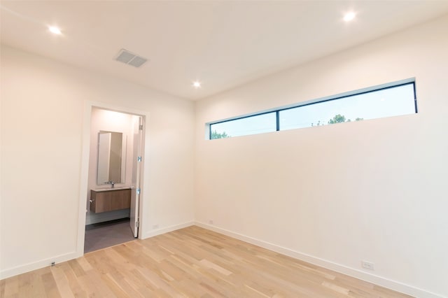 spare room with light hardwood / wood-style flooring and a wealth of natural light