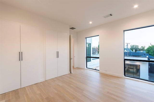 spare room featuring light wood-type flooring