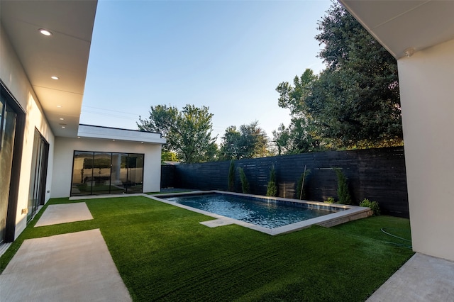 view of pool featuring a yard