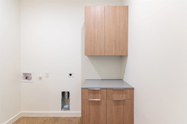 clothes washing area featuring washer hookup, cabinets, hookup for a gas dryer, and hookup for an electric dryer