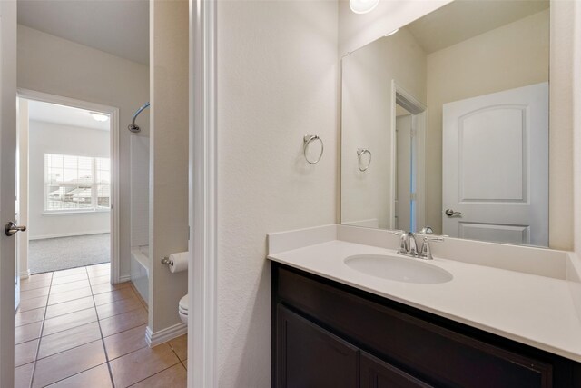 bathroom featuring vanity, washtub / shower combination, and tile patterned flooring