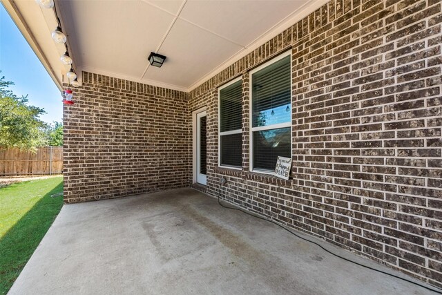 back of house with a patio and a lawn