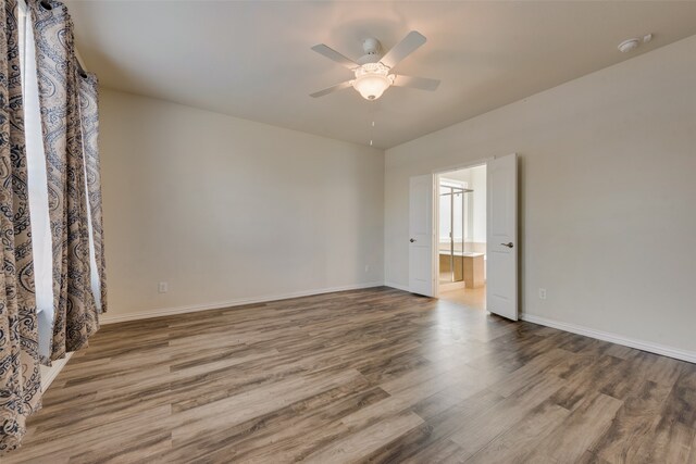 unfurnished room featuring ceiling fan and hardwood / wood-style floors