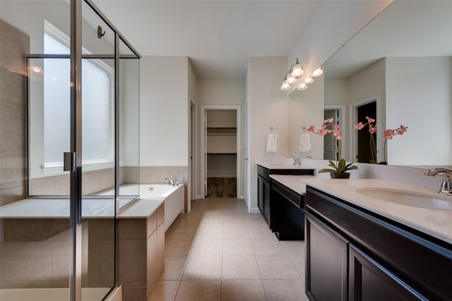 bathroom with tile patterned flooring, vanity, and shower with separate bathtub