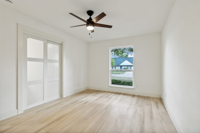 empty room featuring ceiling fan and light hardwood / wood-style flooring