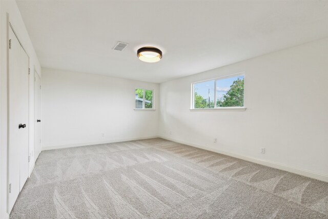 unfurnished bedroom with light colored carpet