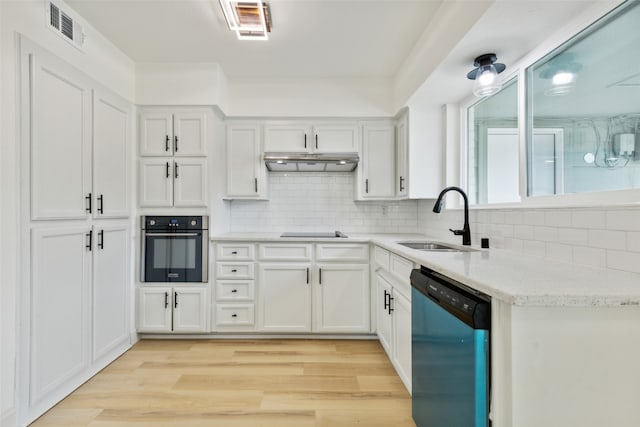 kitchen featuring white cabinetry, sink, light hardwood / wood-style flooring, and stainless steel appliances