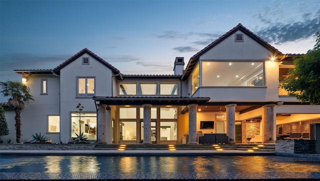 rear view of house featuring an outdoor hangout area and a patio