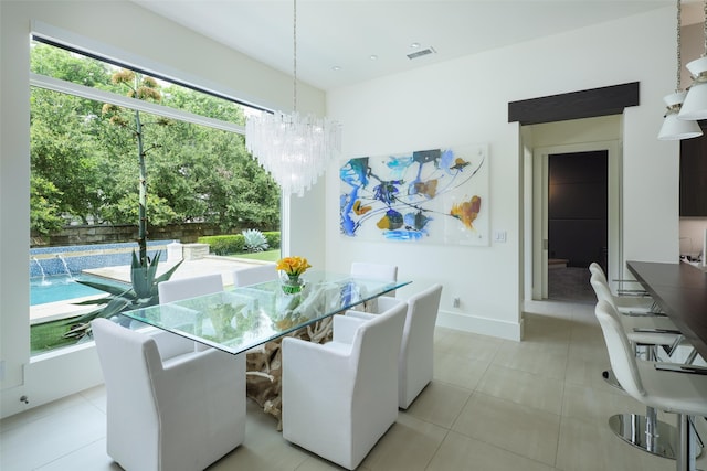 tiled dining room with a notable chandelier