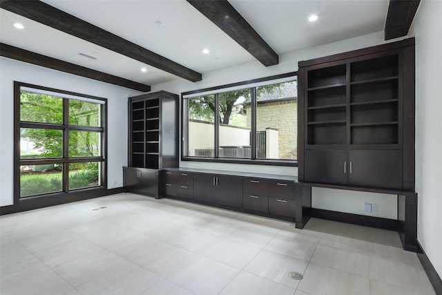 interior space featuring beam ceiling and light tile patterned floors